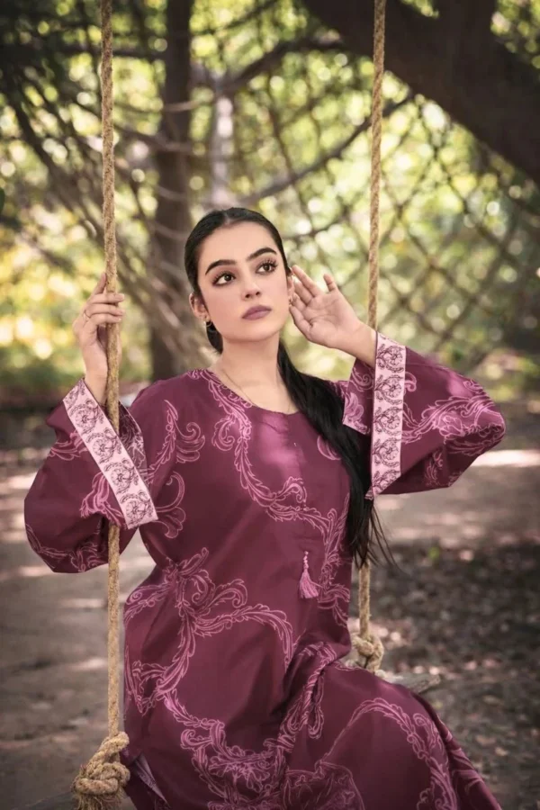 Girl on swing wearing purple shirt — Ruby