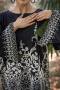 Slate lawn suit detail — close-up of scroll-print border hem and crew neckline, Sarah Tareen