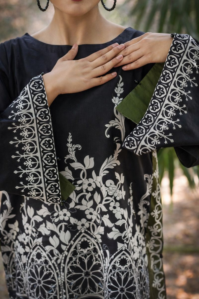 Slate lawn suit detail — close-up of scroll-print border hem and crew neckline, Sarah Tareen