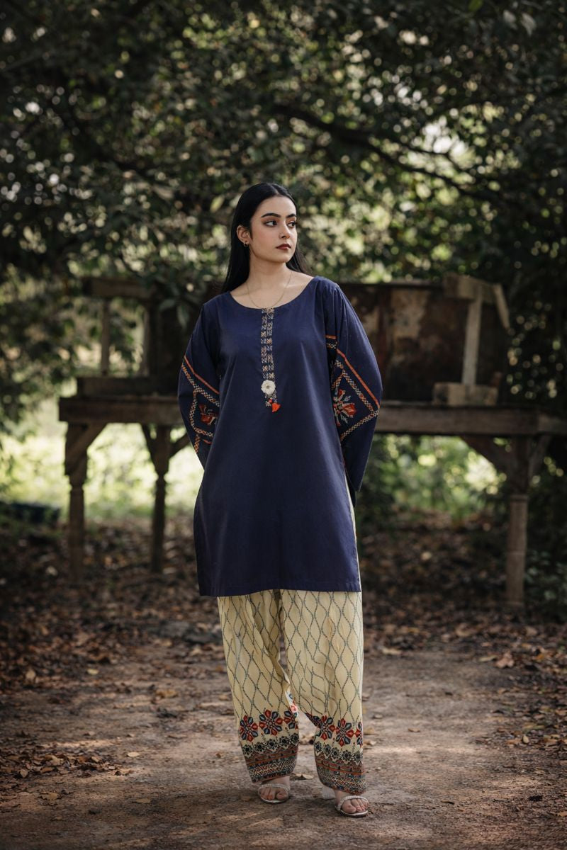 Lux lawn 2-piece — full-length view of geometric print suit with bold border hem trouser, Sarah Tareen