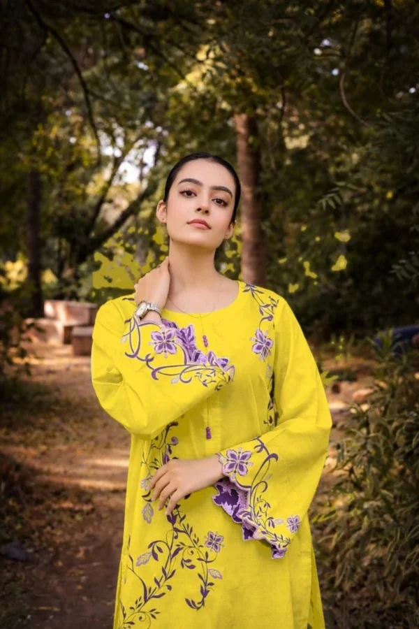 Portrait of model in yellow embroidered shirt with purple floral sleeve detail — Ivy