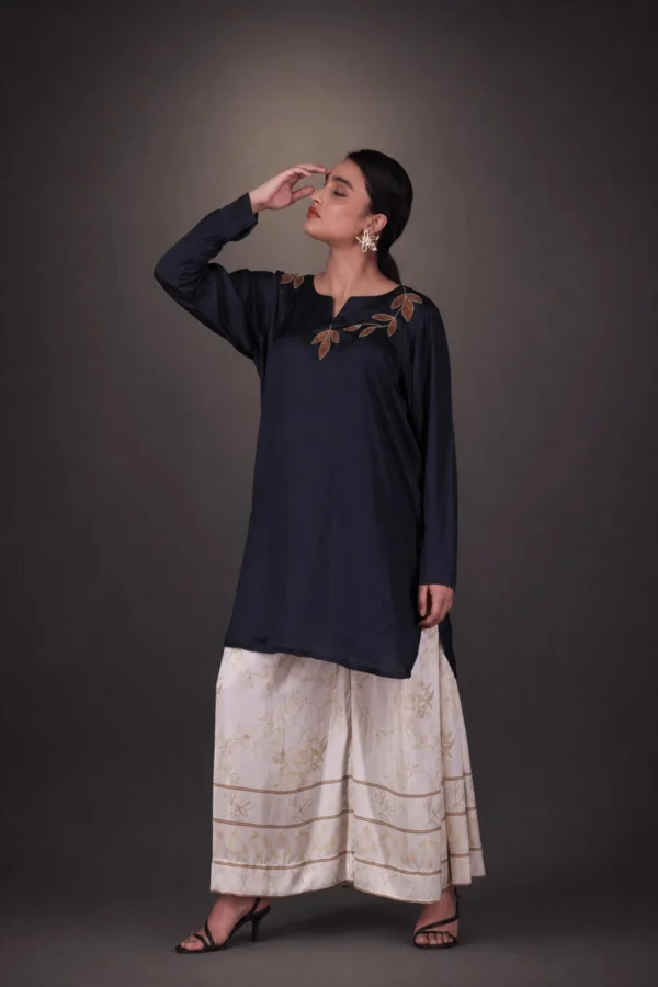 Model in black tunic with ivory floral trousers — Khwab