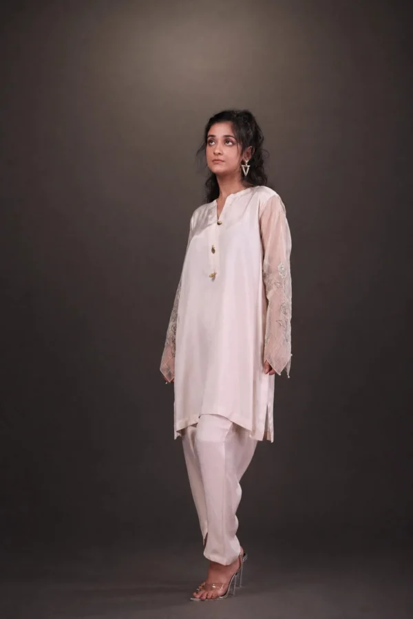 Model in ivory outfit with sheer embroidered sleeves — Gulab-e-Wisal